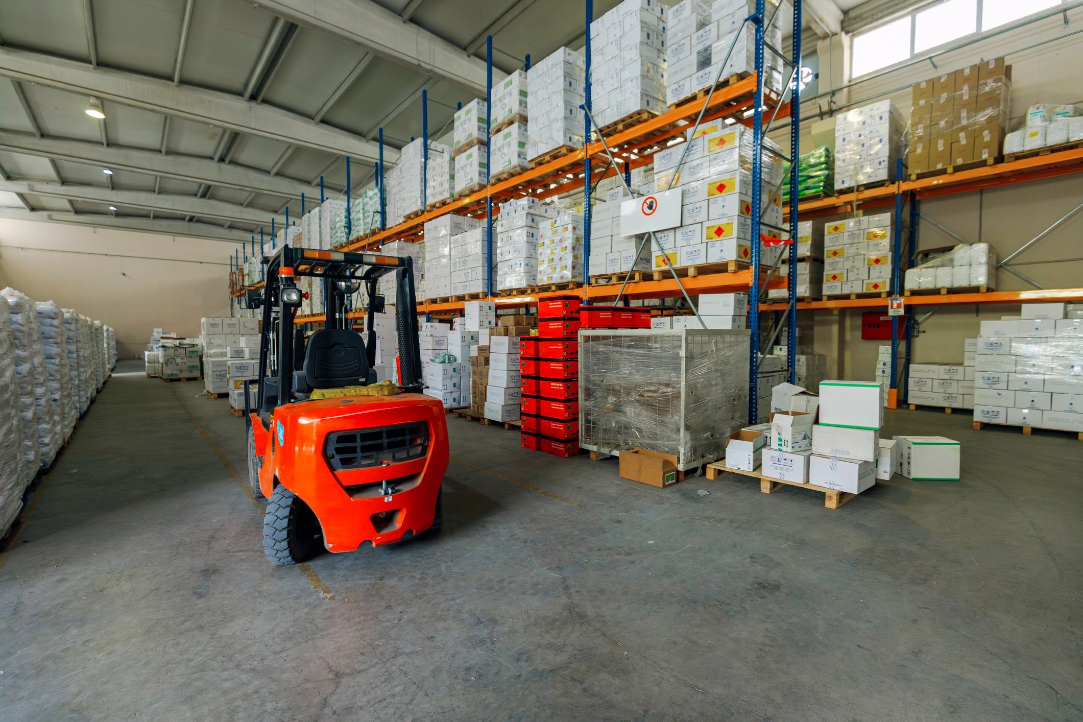 Warehouse aisle with stocked building materials and equipment